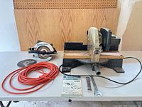 Full lot showing circular saw, table saw, extension cord, spare blade, wrench