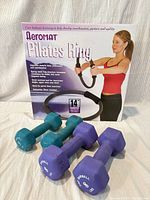 Dumbbells and Pilates ring box displayed together