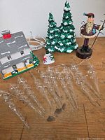 Group shot of village house, trees, Santa, snowman and glass icicles