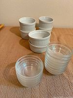 Stacks of six white ramekins and twelve clear glass prep bowls