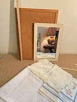 Bulletin board, mirror and folded linens overview