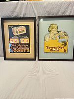 Both framed advertising posters side by side