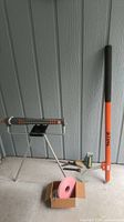 Group shot showing sprinkler on tripod, Stihl pole pruner, packaged nozzle, flagging tape box