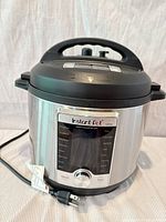 Front view of Instant Pot Ultra multi-cooker with power cord