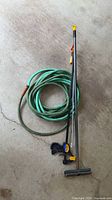 Entire lot showing garden hose, Quick-Grip clamp, bar clamp shaft, and wire brush on pole