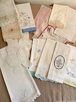 Overview of assorted embroidered linens laid out