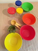 Group shot of all items: bowls, measuring tools, jars with lids