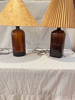 Pair of amber glass lamps with shades side by side