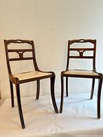 Front view of both dining chairs showing full design and upholstery