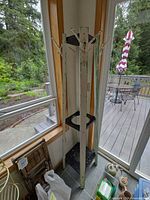 Full view of tall wooden rack with hooks, shelves and distressed finish