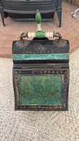 Front view showing green panel, ceramic handle, gilt detailing