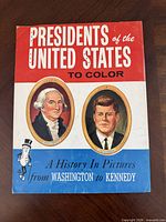Front cover showing title, portraits of Washington and Kennedy, Mr. Peanut mascot