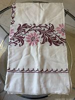 tablecloth folded showing overall embroidered vine pattern