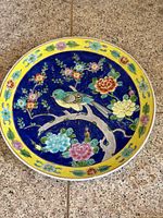 Full view of hand-painted porcelain plate showing overall design and colour palette