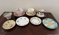 Overview of four teacups each on saucer plus four additional saucers