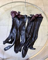 full view of both gloves showing overall design and bows