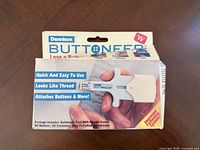 Front of Dennison Buttoneer box showing tool image and contents list