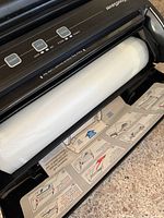 Open unit showing internal roll holder, cutter and bag roll