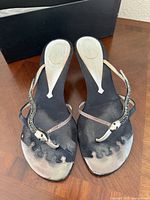 Top view of both sandals showing overall design, straps, wear on footbeds