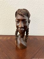 Frontal view of carved wooden bust