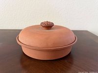 Side view of terracotta tortilla warmer with lid on
