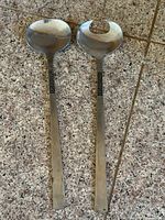 full view of both stainless steel salad servers showing spoon and fork