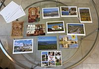 All postcards laid out on round glass table