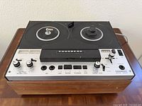 Front angled view of Tandberg Series 6000X showing reels, controls, wood cabinet