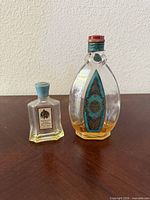 Tosca Eau De Cologne 4711 oval glass bottle and Yardley English Lavender miniature bottle, both partly filled