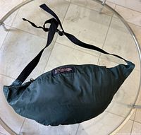 Windbreaker folded into fanny pack showing Jansport patch and strap