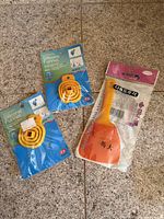 overview showing two packaged yellow silicone funnels and one packaged orange spatula