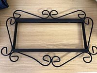 Full view of wrought iron scrollwork frame