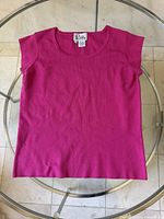 Front view of pink Lilly Pulitzer silk blouse showing full garment and label placement