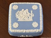 Top view showing lid design with central classical scene, four rosette medallions and floral border