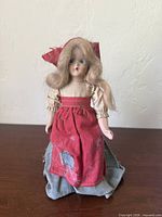 front view of doll showing face, hair and outfit