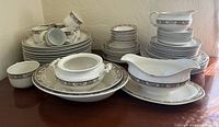 Full view of stacked dinner plates, cups, saucers, bowls, platters and serving pieces