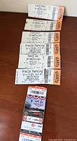 Seven ticket and parking stubs laid out in a column