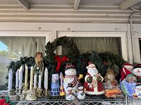 Overall lot showing wreath, garland, candelabra, ceramic cookie jars, snowman figurines, dolls, ornaments