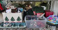 Shelf showing entire assortment of Christmas decorations, bins and boxes