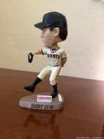 Left side view of Barry Zito bobblehead showing pitching pose and Toshiba base detail