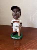 Front view of Barry Bonds bobblehead on green base marked 'the chronicle'