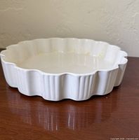 Top angled view of white scalloped pie dish