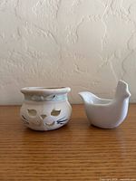 Front view of cat tealight holder and bird creamer