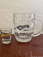 Beer mug and shot glass front view showing multicolor and black logos