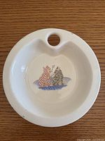 Top view of ceramic baby dish warmer showing cat design and water-fill hole