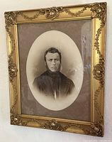 Full view of framed portrait on wall