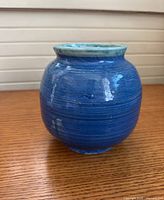 Front view of blue vase showing shape and glaze