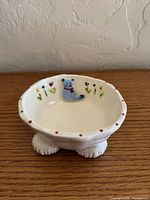 Top view showing painted cat, flowers, dotted rim