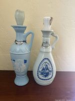 Both Jim Beam decanters side by side showing overall form and stoppers