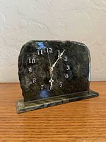 Front view of marble mantle clock showing numerals and hands